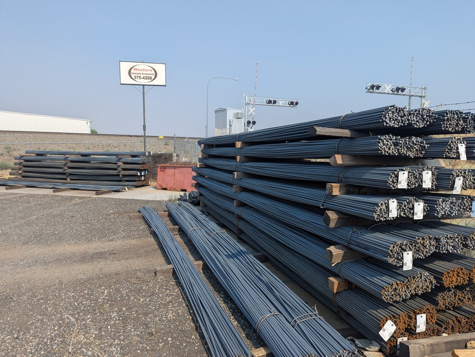 Bundles of rebar stacked in our Richland yard, with our sign in the background
