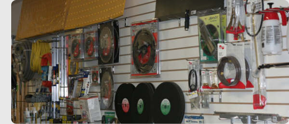 Shelves of concrete finishing blades, tools, and hardware in our showroom