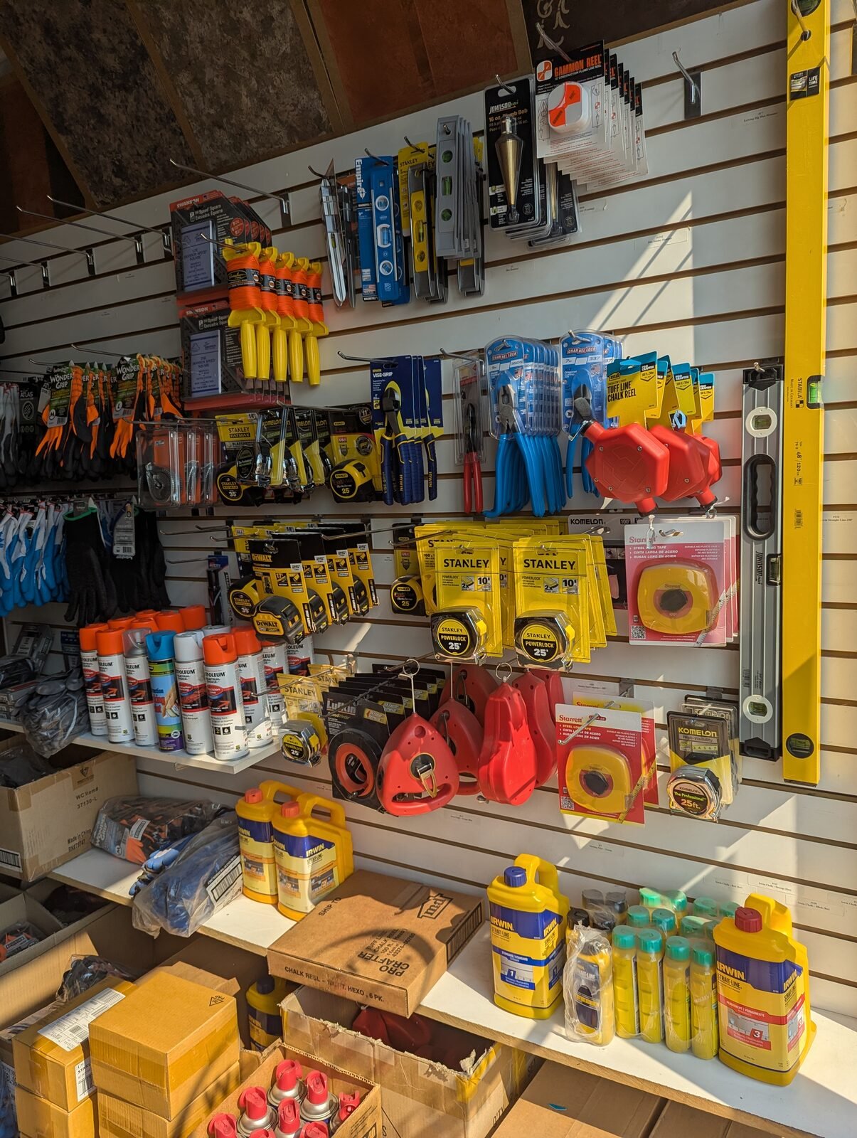 Wall of hand tools, levels, tape measures, and chalk reels in our showroom